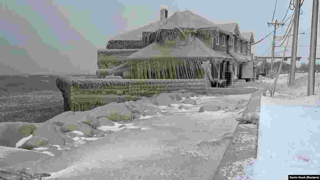 Hoak's restaurant is covered in ice from the spray of Lake Erie waves during a winter storm that hit the Buffalo region in Hamburg, New York, Dec. 24, 2022.