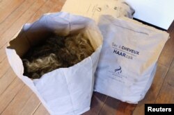 Tas berisi rambut manusia di salon rambut Helyode di Brussel, Belgia, 4 November 2022. (REUTERS/Yves Herman)