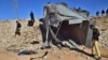 FILE - Pakistani security officials inspect a damaged truck at the site of suicide bombing on the outskirts of Quetta, Pakistan, Nov. 30, 2022. The Tehrik-i-Taliban Pakistan, also known as the Pakistani Taliban, claimed responsibility for the attack