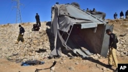 FILE - Pakistani security officials inspect a damaged truck at the site of suicide bombing on the outskirts of Quetta, Pakistan, Nov. 30, 2022. The Tehrik-i-Taliban Pakistan, also known as the Pakistani Taliban, claimed responsibility for the attack