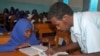 FILE - A Somali teacher explains the lesson to students inside a school classroom in Mogadishu, Somalia. 