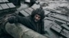 A Ukrainian soldier looks out of a captured Russian tank on the front line in Ukraine's Donetsk region, Nov. 22, 2022.