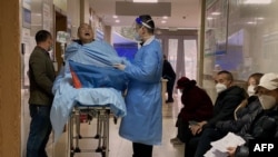 An elderly COVID-19 patient lies on a stretcher in the emergency ward of the First Affiliated Hospital of Chongqing Medical University in China's southwestern city of Chongqing, Dec. 22, 2022. 