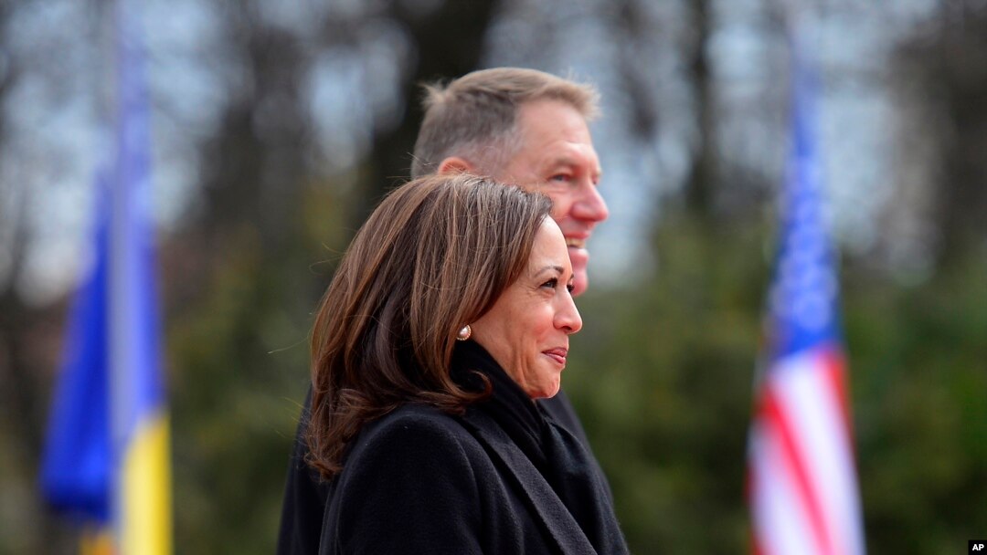 U.S. Vice President Kamala Harris, foreground, and Romanian President Klaus Iohannis attend a welcome ceremony in Bucharest, Romania, March 11, 2022. 