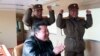 This picture taken March 24, 2022, and released from North Korea's official Korean Central News Agency on March 25, shows North Korean leader Kim Jong Un, center, reacting to a test launch of a new inter-continental ballistic missile in an undisclosed location in North Korea.