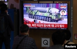 People watch a TV broadcasting a news report on North Korea's intercontinental ballistic missile (ICBM) test, in Seoul, South Korea, March 24, 2022. (Yonhap via Reuters)