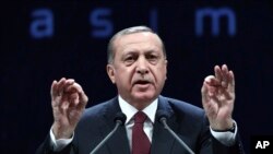 Turkey's President addresses police officers in Ankara, Turkey, Nov. 22, 2016. Turkey's government on Tuesday dismissed an additional 15,000 people from the military, police and the civil service as part of an ongoing investigation into the failed military coup in July.