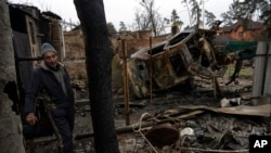 A man stands inside a destroyed home in Irpin, on the outskirts of Kyiv, Ukraine, April 2, 2022.
