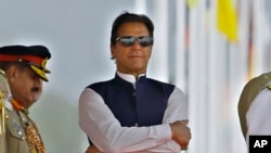 FILE - Pakistan's Prime Minister Imran Khan attends a military parade to mark Pakistan National Day, in Islamabad, Pakistan, March 23, 2022.