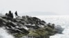 FILE - Venezuelan security forces guard the shore and a boat in the port city of La Guaira, Venezuela, May 3, 2020. 