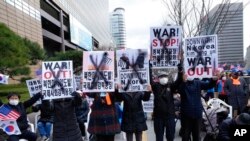 Para pengunjuk rasa di dekat Kedutaan Besar AS di Seoul, Korea Selatan, menunjukkan poster-poster berisi protes terhadap peluncuran misil Korea Utara, 26 Maret 2022. 