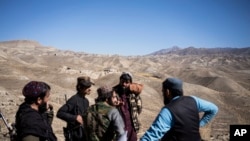 FILE - Taliban soldiers stand guard in Mes Aynak valley, southwest of Kabul, Oct. 30, 2021. The valley holds the world's second-largest untapped copper deposit estimated to be worth nearly $1 trillion.