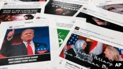 FILE - Some of the Facebook and Instagram ads linked to a Russian effort to disrupt the American political process and stir up tensions around divisive social issues, released by members of the U.S. House Intelligence committee, are photographed in Washin