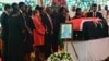 Family and friends stand near the flag-draped coffin of former Kenyan President Mwai Kibaki as he lies in state during a memorial service at the Nyayo National Stadium in Nairobi, April 29, 2022.

