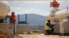 FILE - Men work on a new pipeline near Komotini, northern Greece, March 21, 2022. Crossing a remote border area of Greece and Bulgaria, the pipeline will help countries in the region dependent on Russian imports gain greater access to the global natural gas market.