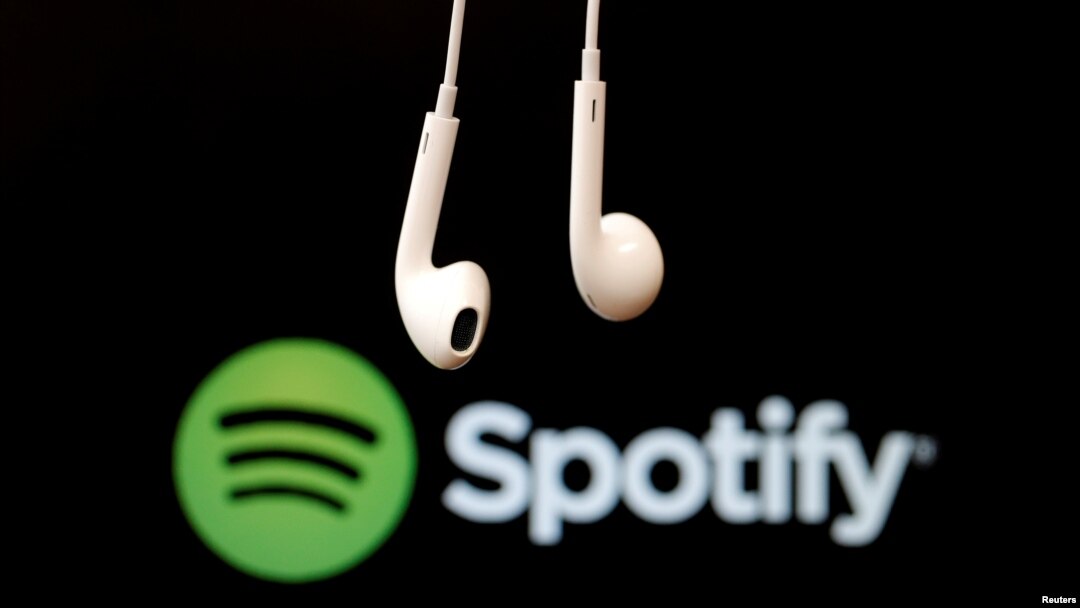 FILE - Headphones are seen in front of a logo of online music streaming service Spotify in this Feb. 18, 2014 illustration picture. 