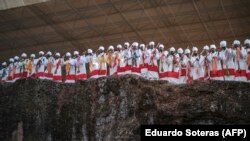 FILE - Priests chant and dance during the celebration of Genna, the Ethiopian Orthodox Christmas, at Saint Mary's Church in Lalibela, Ethiopia, Jan. 7, 2022.