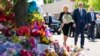 President Joe Biden and first lady Jill Biden pay their respects to the victims of Saturday's shooting at a memorial across the street from the TOPS Market in Buffalo, N.Y., May 17, 2022.