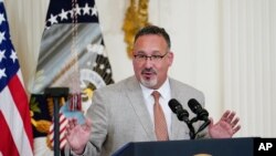 FILE - Education Secretary Miguel Cardona speaks during a White House event, April 27, 2022. As of Wednesday, he said, the Biden-Harris administration will discharge the federal student loans of "every student deceived, defrauded and driven into debt by Corinthian Colleges."