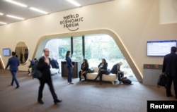 FILE - Participants are seen at the congress hall, the venue of the World Economic Forum 2022 in the Alpine resort of Davos, Switzerland, May 23, 2022.