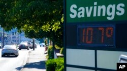 FILE - In this June 28, 2021 file photo a display at an Olympia Federal Savings branch shows a temperature of 107 degrees Fahrenheit, (42 degrees Celsius) in the early evening in Olympia, Wash.
