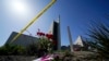Flowers sit outside crime scene tape at Geneva Presbyterian Church on May 17, 2022, in Laguna Woods, Calif. A shooting at the church on Sunday left one dead and five injured.
