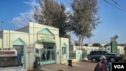 A woman leaves Mame Abdou Aziz Sy Dabakh Hospital in Tivaouane, Senegal where 11 newborns died in a fire Wednesday night. (Annika Hammerschlag/VOA)