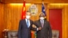 In this photo released by Xinhua News Agency, Solomon Islands Prime Minister Manasseh Sogavare locks arms with visiting Chinese Foreign Minister Wang Yi in Honiara, Solomon Islands, May 26, 2022. 
