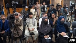 FILE - Afghan journalists attend a press conference held by the Taliban's acting first deputy prime minister Abdul Ghani Baradar (not pictured) and other officials in Kabul, May 24, 2022. Many Afghan journalists have fled the country since the Taliban took over in August 2021.
