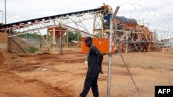 FILE - A private security employee guards a diamond processing plant in the diamond-rich eastern Marange region on December 14, 2011.
