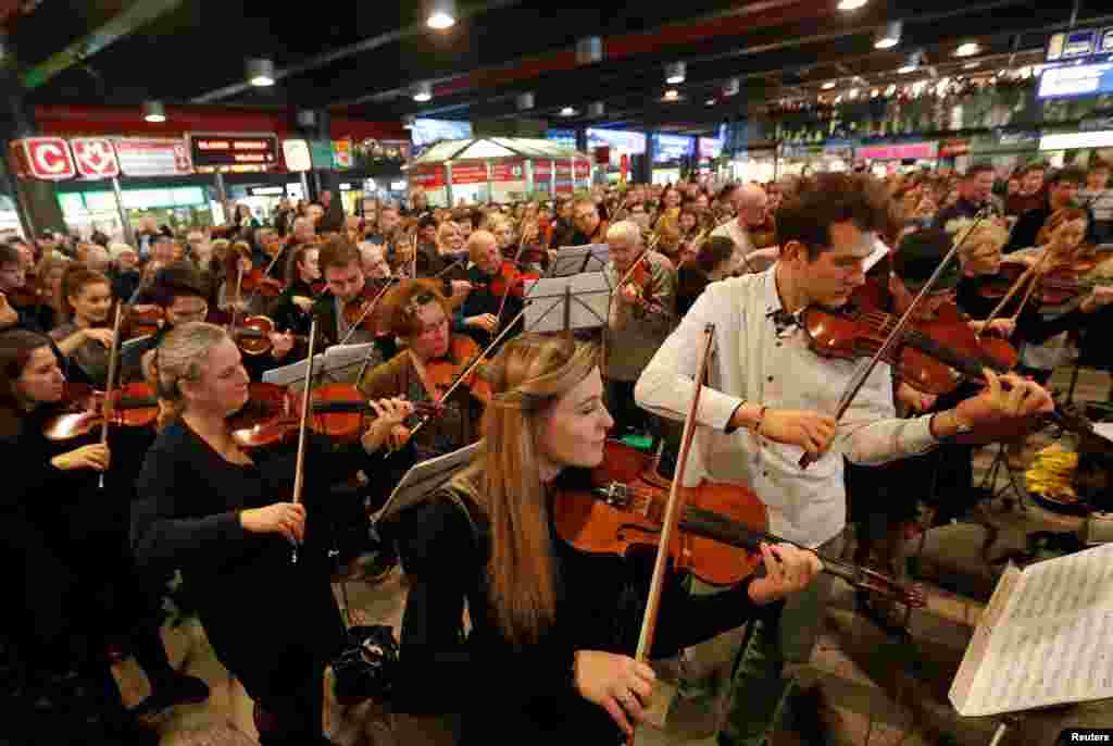 People play instruments during the performance of "Czech Christmas Mass" by the Czech composer Jakub Jan Ryba at Prague's main railway station, Czech Republic.