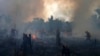 FILE - Fire brigade members work to put out fires in Apui, Amazonas state, Brazil, Sept. 21, 2022. Deforestation in the Brazilian Amazon slowed slightly last year, a year after a 15-year high, according to closely watched numbers published Nov. 30.