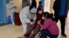 A patient with Covid-19 coronavirus is assisted at Fengyang People's Hospital in Fengyang County in east China's Anhui Province on Jan. 5, 2023. 