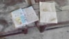 แฟ้มภาพ - หนังสือเรียนวางอยู่บนโต๊ะที่โรงเรียนแห่งหนึ่งในภูมิภาคสะเกียง หลังการโจมตีทางอากาศที่โรงเรียนดังกล่าวเมื่อวันที่ 17 ก.ย. 2022