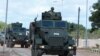 FILe - A Somalia National Army (SNA) soldier rides on an armored personnel carrier during celebrations on their 62nd anniversary in Mogadishu, Apr. 12, 2022. 