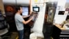 FILE - A worker at Reata Engineering and Machine Works programs a Mazak Variaxis machine used to make semiconductor pieces on Feb. 15, 2024, in Englewood, Colorado. A U.S. employment report released on June 7, 2024, showed continued strength in added jobs.
