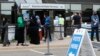 FILE - Voters, among them Somali Americans, line up to cast their ballots in primary elections, at the Minneapolis Election and Voters Services offices, in Minneapolis, Minnesota, Aug. 10, 2020.