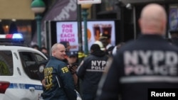 Law enforcement officers work near the scene of a shooting at a subway station in the Brooklyn borough of New York City, New York, U.S., April 12, 2022.