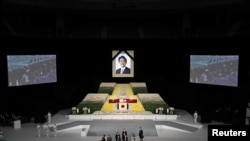 Widow of former Japanese Prime Minister Shinzo Abe, Akie Abe carries her husband's urn during the state funeral for Japan's former Prime Minister Shinzo Abe at the Budokan in Tokyo, Japan, Sept. 27, 2022. (Takashi Aoyama/Pool via Reuters)