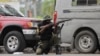 FILE - A soldier positions himself outside the military base near the presidential palace in Port-au-Prince, Haiti, after gangs waged intense gun battles, shuttering main avenues and a municipal market in the downtown area, July 27, 2022. 