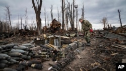 An interior ministry sapper collects unexploded shells, grenades and other devices in Hostomel, close to Kyiv, Ukraine, April 18, 2022.