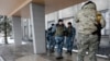Ukrainian soldiers stand outside the city council building in the town of Debaltseve, Ukraine, Jan. 31, 2015. 