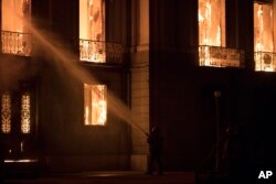 Firefighters spray the flames at the 200-year-old National Museum of Brazil, in Rio de Janeiro, Brazil, Sept. 2, 2018.