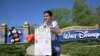 Nicholas Maldonado protests Disney's stance on LGBTQ issues while he participates in an employee walkout at Disney World on March 22, 2022.