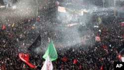 Mourners attend a funeral ceremony for Iranian Gen. Qassem Soleimani and his comrades, who were killed in Iraq in a U.S. drone strike on Friday, at the Enqelab-e-Eslami (Islamic Revolution) square in Tehran, Iran, Monday, Jan. 6, 2020. (AP Photo…