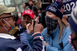 Trump supporters at right argue with a counter protestor at left as they protest election results outside the central counting board at the TCF Center in Detroit, Mich., Thursday, Nov. 5, 2020.