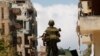 A Lebanese army soldier stands atop of an armored personnel carrier (APC) patrolling the area near a mosque complex where hardline Sunni cleric Sheikh Ahmed al-Assir was believed to be sheltering with his supporters, in Abra near Sidon, southern Lebanon, 