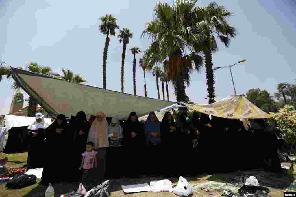 Protesters, who support former Egyptian President Mohamed Morsi, perform Friday prayers near Cairo University in Cairo, July 5, 2013. 