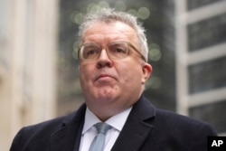 Former British lawmaker Tom Watson speaks outside the High Court in London on Jan. 22, 2025, about News Group's settlement regarding allegations of unlawful information gathering.