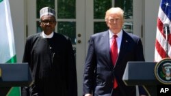 President Donald Trump and Nigerian President Muhammadu Buhari arrive for a news conference in the Rose Garden of the White House in Washington, April 30, 2018.